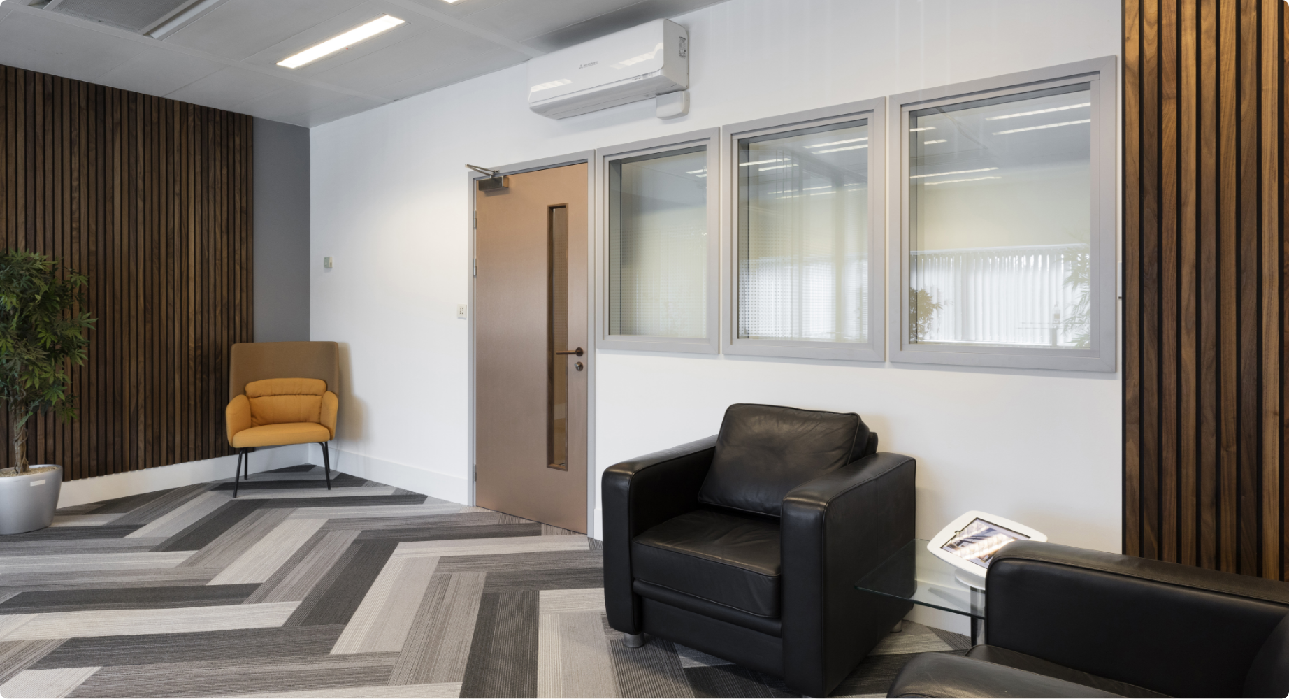 Acoustic sliding glass doors for a busy corporate office
